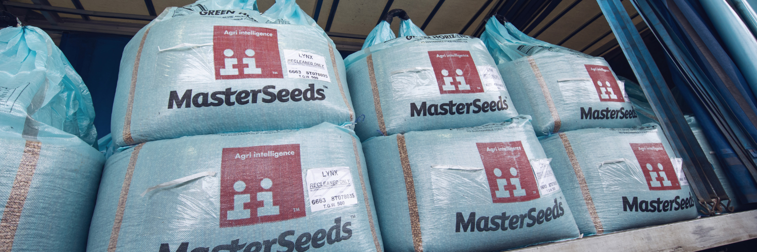 Stacked AgriiSeed blue bags on lorry awaiting delivery